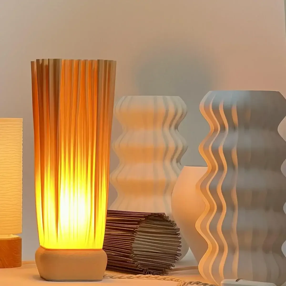 Monoprisma table lamps in studio with two finished lamps and several lamp forms in progress.